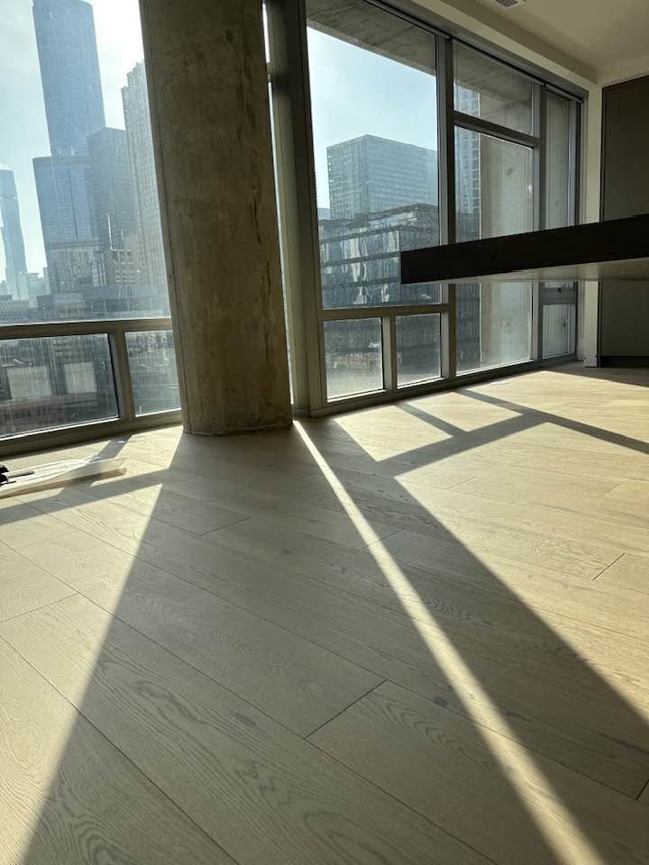 Finished hardwood floor meeting architectural details in an MGM Chicago high-rise project