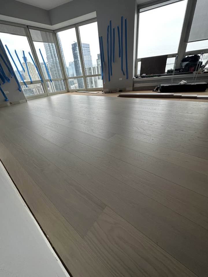 Finished wood flooring across a bright MGM project interior