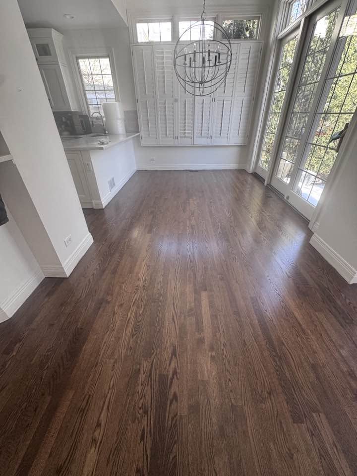 Dark finished hardwood across an open MGM project interior