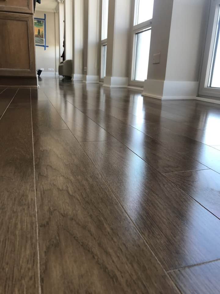 Light hardwood flooring fitted around cream-colored posts in an MGM project