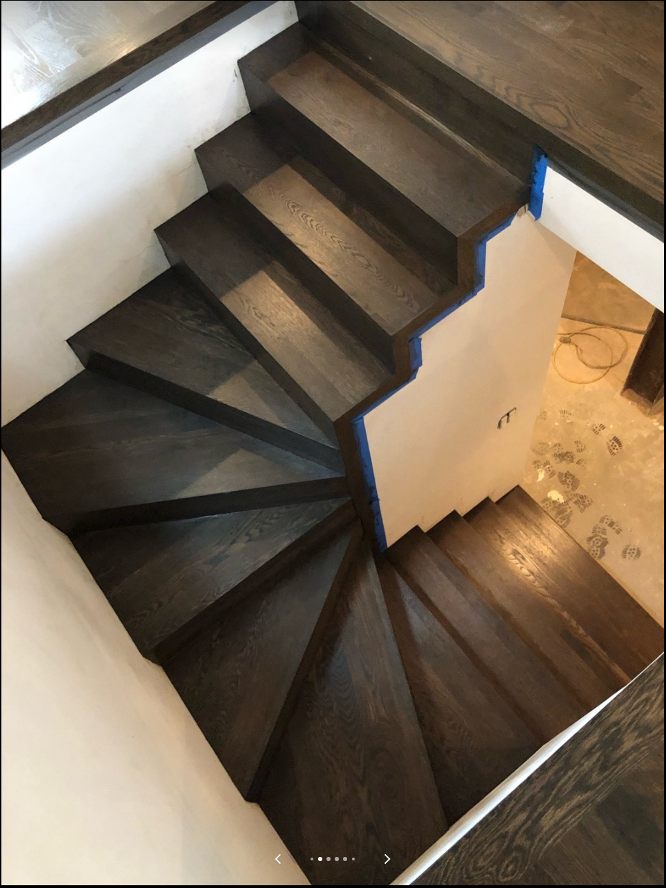 Curved staircase with completed dark wood treads